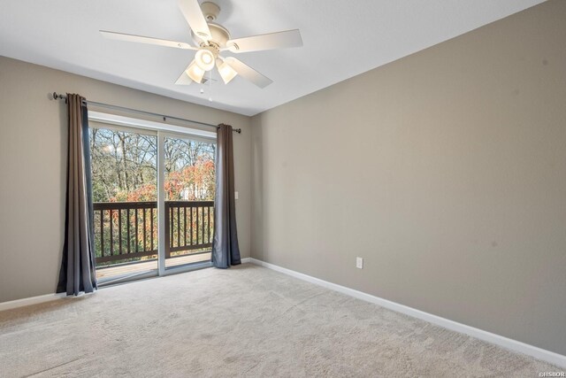 spare room with light carpet, ceiling fan, and baseboards