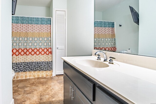 bathroom with a closet and vanity