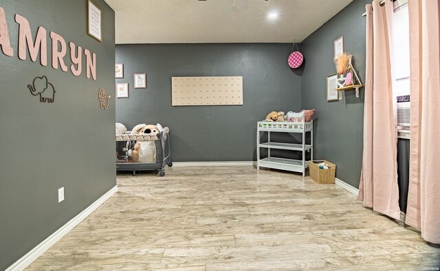 rec room featuring baseboards and wood finished floors