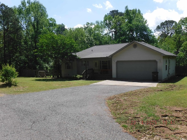 ranch-style home featuring an attached garage, driveway, and a front yard