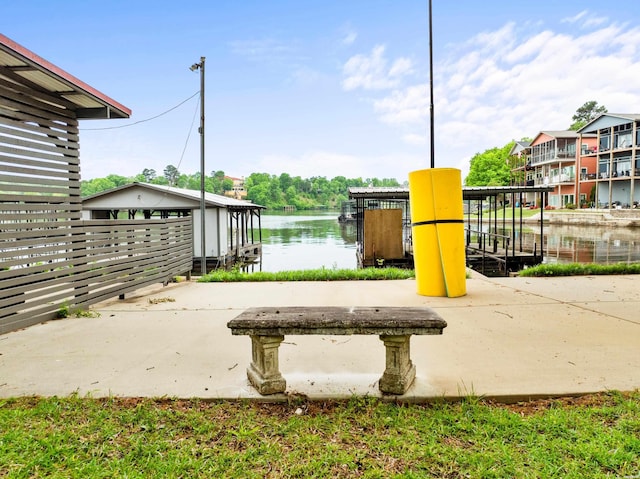 view of play area with a dock and a water view