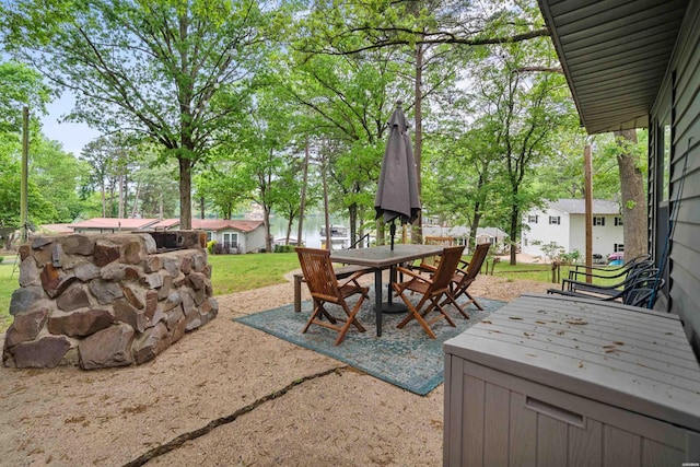 view of patio featuring outdoor dining area and a hot tub