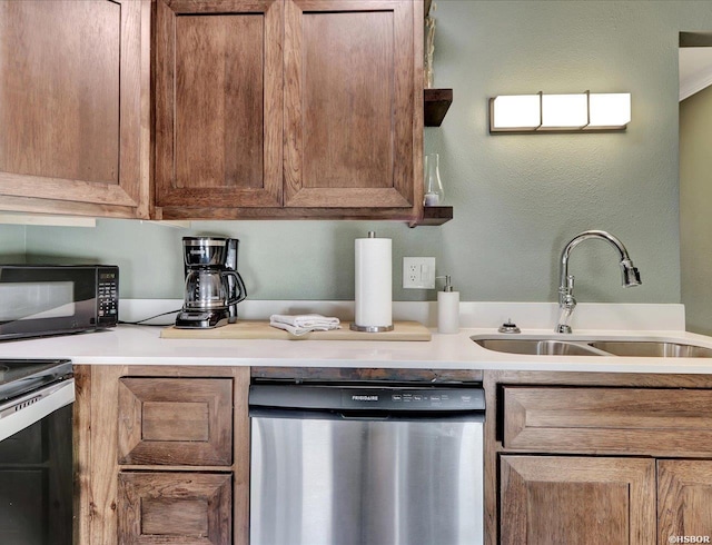 kitchen featuring brown cabinetry, appliances with stainless steel finishes, light countertops, and a sink