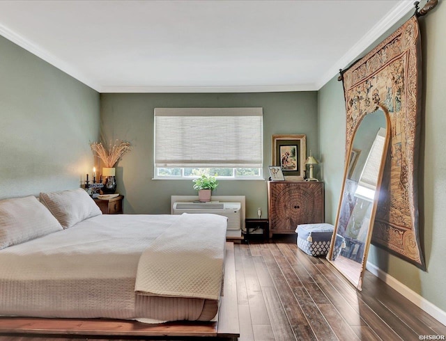 bedroom featuring a wall unit AC, dark wood-style floors, baseboards, and ornamental molding