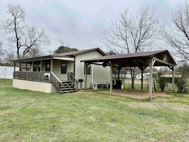 exterior space featuring a carport, a porch, a front yard, and driveway