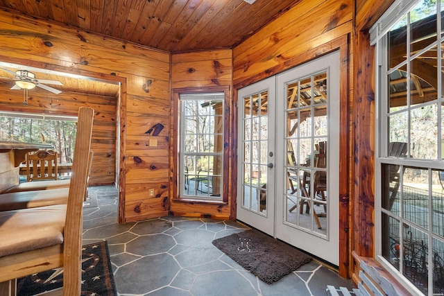 doorway to outside with wood walls, wood ceiling, ceiling fan, and french doors