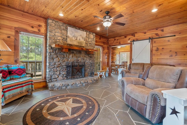 living room featuring a ceiling fan, wood walls, wood ceiling, and recessed lighting