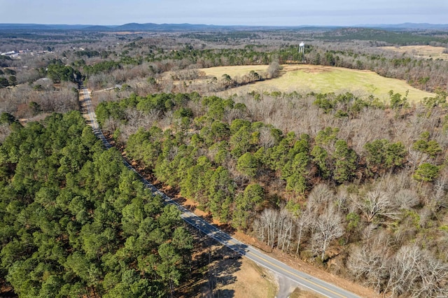 drone / aerial view featuring a wooded view