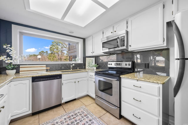 1201 Lakeshore Dr Unit 25, Hot Springs, AR 71913 - kitchen with white cabinetry, tasteful backsplash, light tile patterned floors, stainless steel appliances, and a sink