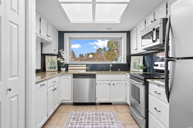 1201 Lakeshore Dr Unit 25, Hot Springs, AR 71913 - kitchen featuring light tile patterned flooring, a sink, white cabinets, and appliances with stainless steel finishes