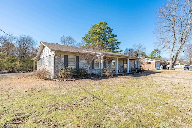 ranch-style home with a front yard, a porch, and brick siding