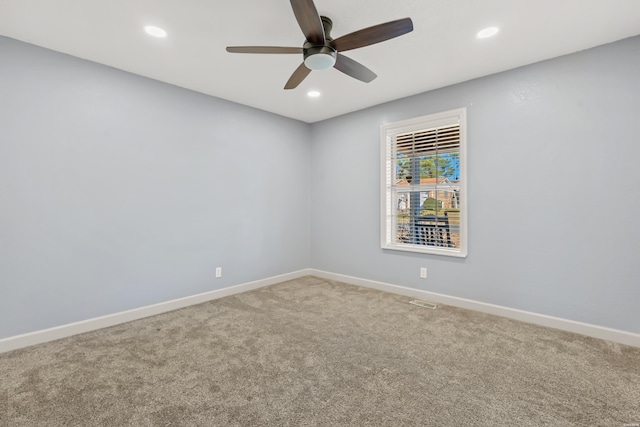 carpeted spare room featuring recessed lighting, a ceiling fan, and baseboards