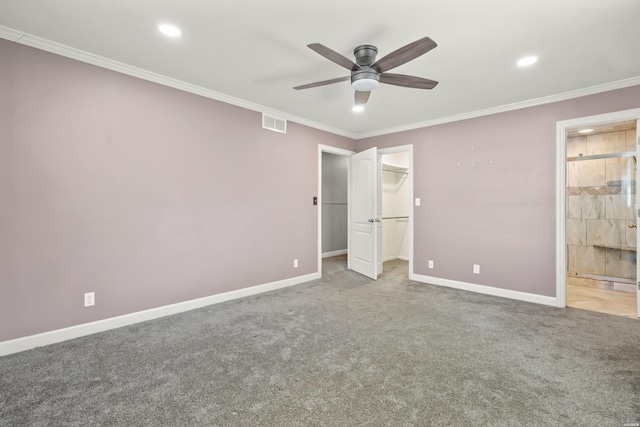 unfurnished bedroom with ornamental molding, visible vents, carpet floors, and baseboards