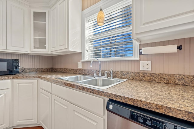 kitchen featuring white cabinets, glass insert cabinets, stainless steel dishwasher, black microwave, and a sink