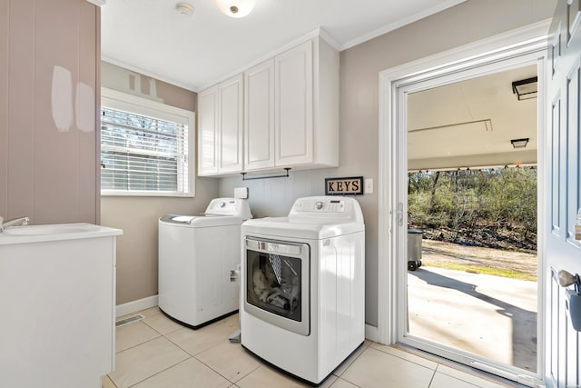 clothes washing area with light tile patterned floors, visible vents, cabinet space, and independent washer and dryer