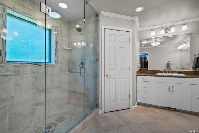 bathroom with crown molding, recessed lighting, a stall shower, vanity, and tile patterned flooring