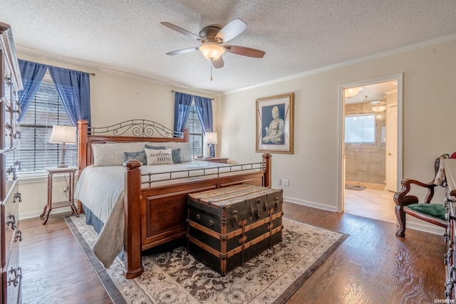 bedroom featuring a textured ceiling, ornamental molding, and wood finished floors