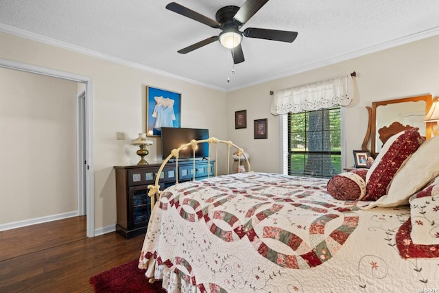 bedroom featuring crown molding, a textured ceiling, baseboards, and wood finished floors