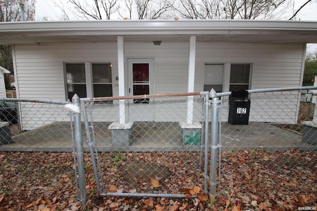 doorway to property with a gate and fence