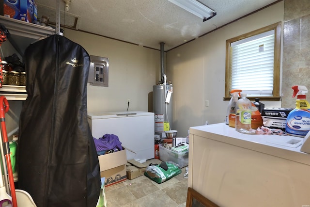 laundry area featuring water heater, a textured ceiling, laundry area, electric panel, and independent washer and dryer