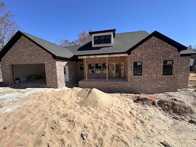 view of front of property featuring an attached garage and brick siding