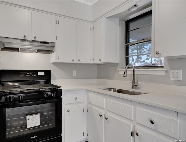 kitchen with black gas range, light countertops, under cabinet range hood, white cabinetry, and a sink