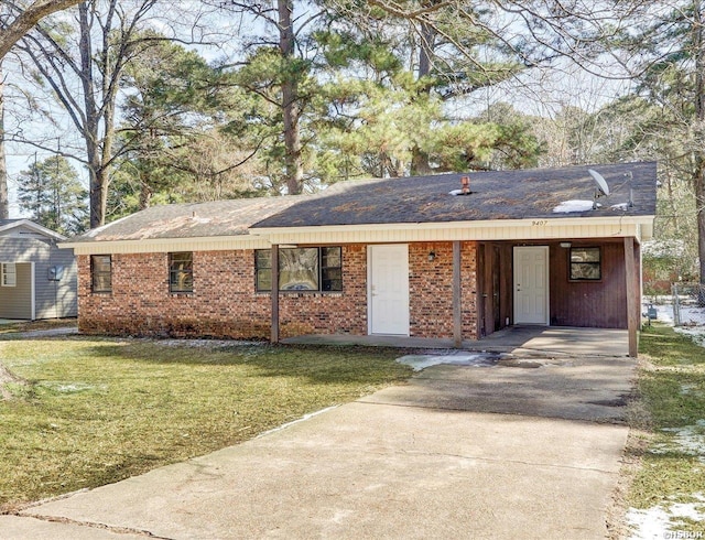 ranch-style home with a front yard, concrete driveway, and brick siding