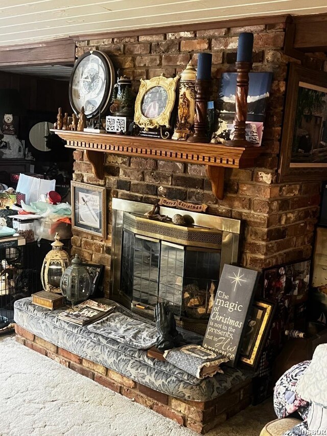 room details featuring carpet floors and a large fireplace