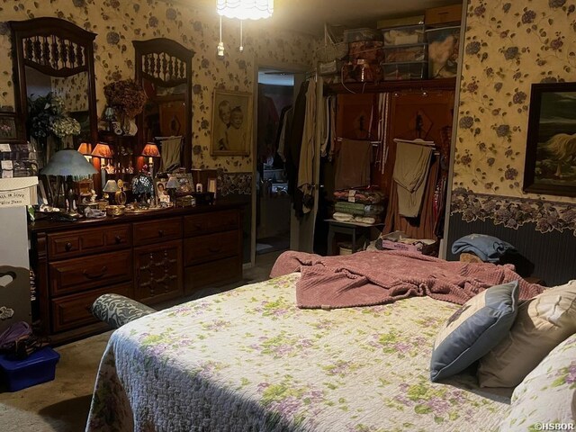 carpeted bedroom featuring wallpapered walls