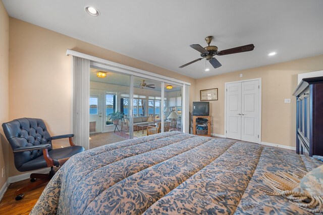 bedroom featuring access to outside, wood finished floors, baseboards, and recessed lighting