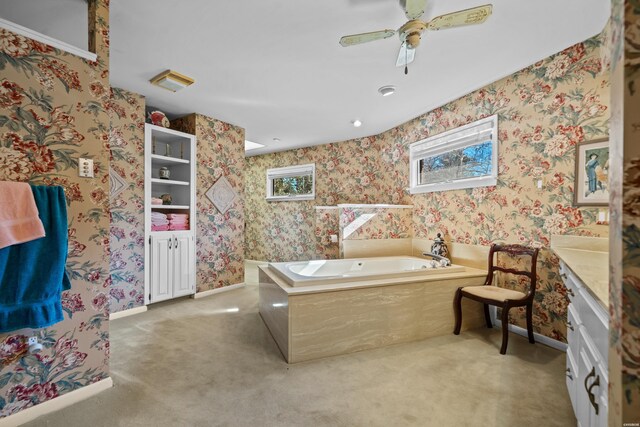 bathroom featuring a healthy amount of sunlight, baseboards, a bath, and wallpapered walls