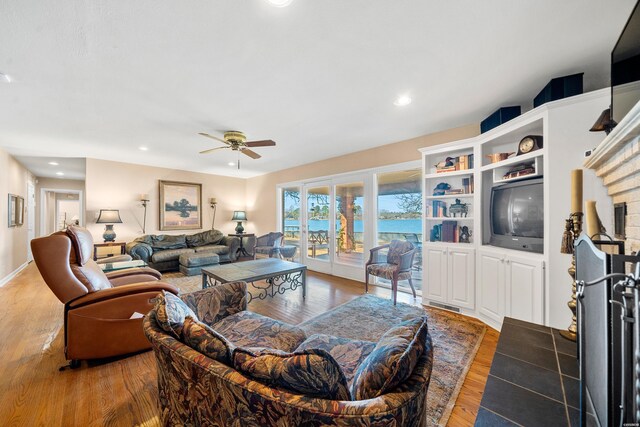 living area with a ceiling fan, wood finished floors, and recessed lighting