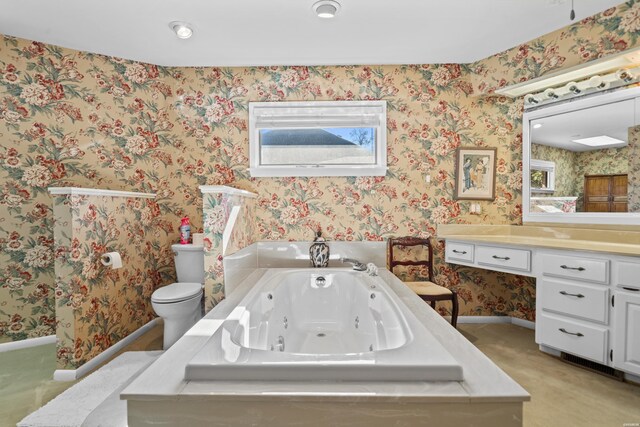 bathroom with a jetted tub, toilet, and wallpapered walls