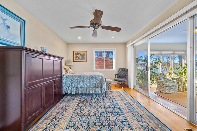 bedroom with access to exterior, recessed lighting, ceiling fan, and wood finished floors