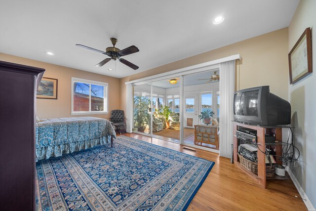 bedroom featuring access to outside, multiple windows, light wood-style flooring, and recessed lighting