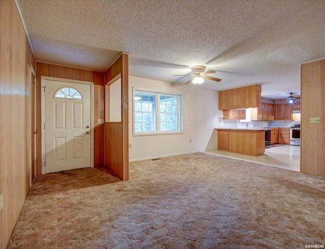 427 Morrison Rd, Arkadelphia, AR 71923 - entryway with ceiling fan, wood walls, plenty of natural light, light colored carpet, and a textured ceiling