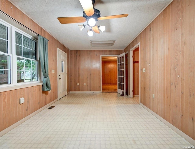 427 Morrison Rd, Arkadelphia, AR 71923 - empty room with wood walls, attic access, a textured ceiling, and a ceiling fan