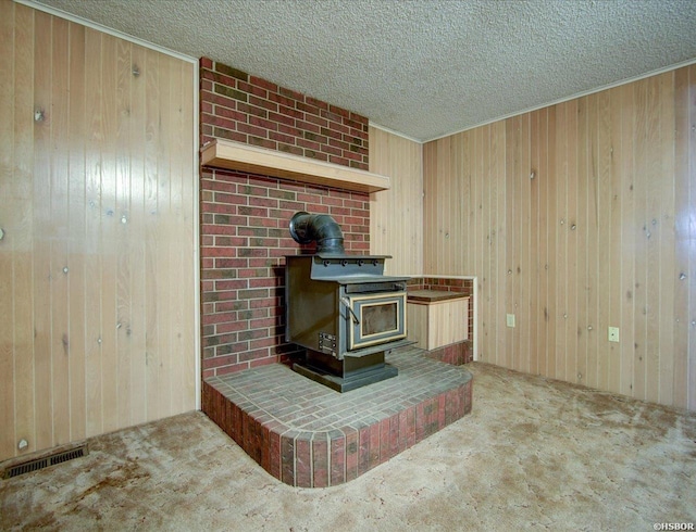 427 Morrison Rd, Arkadelphia, AR 71923 - detailed view of a wood stove, wooden walls, a textured ceiling, and carpet