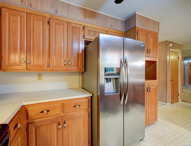 427 Morrison Rd, Arkadelphia, AR 71923 - kitchen with stainless steel fridge, brown cabinetry, light countertops, light flooring, and a textured ceiling