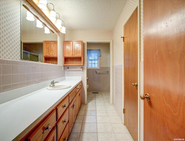 427 Morrison Rd, Arkadelphia, AR 71923 - full bathroom with wallpapered walls, tile walls, vanity, tile patterned flooring, and a wainscoted wall