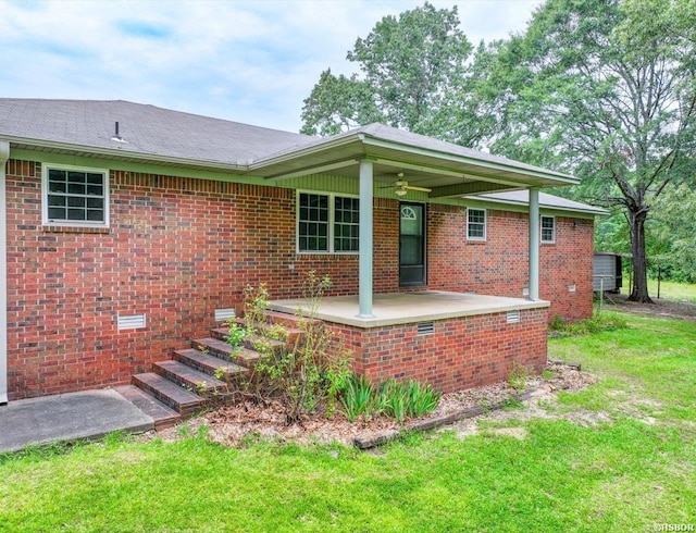 427 Morrison Rd, Arkadelphia, AR 71923 - back of property featuring a ceiling fan, a lawn, and brick siding