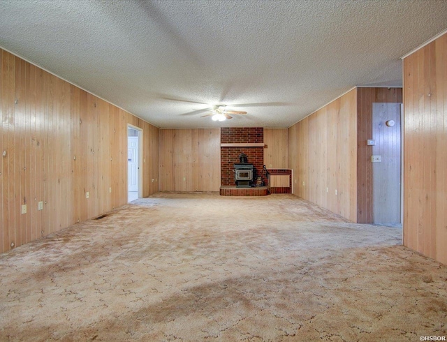427 Morrison Rd, Arkadelphia, AR 71923 - unfurnished living room featuring wooden walls, ceiling fan, carpet, and a textured ceiling
