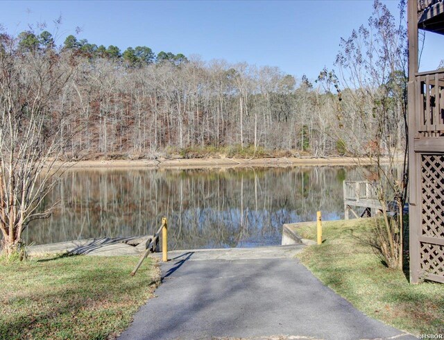 exterior space with a water view and a view of trees