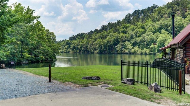 exterior space featuring a forest view and fence