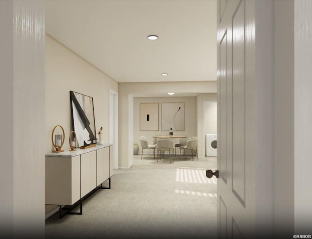 corridor with washer / dryer, recessed lighting, and light colored carpet