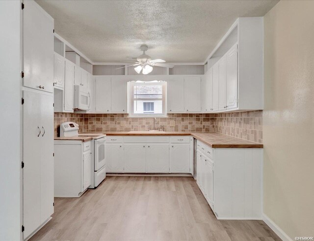 kitchen with light wood finished floors, tasteful backsplash, a ceiling fan, white cabinets, and white appliances