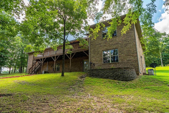 539 Charlie Stover Rd, Royal, AR 71968 - rear view of house featuring a deck, stairway, brick siding, and a yard