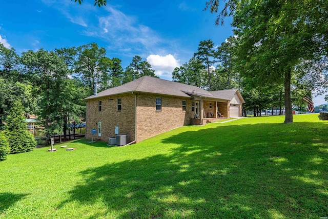 539 Charlie Stover Rd, Royal, AR 71968 - rear view of property with a garage, a lawn, and brick siding