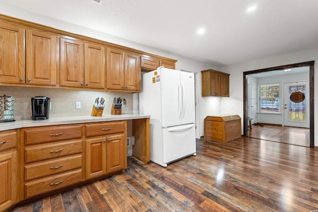539 Charlie Stover Rd, Royal, AR 71968 - kitchen with freestanding refrigerator, dark wood finished floors, light countertops, brown cabinets, and recessed lighting