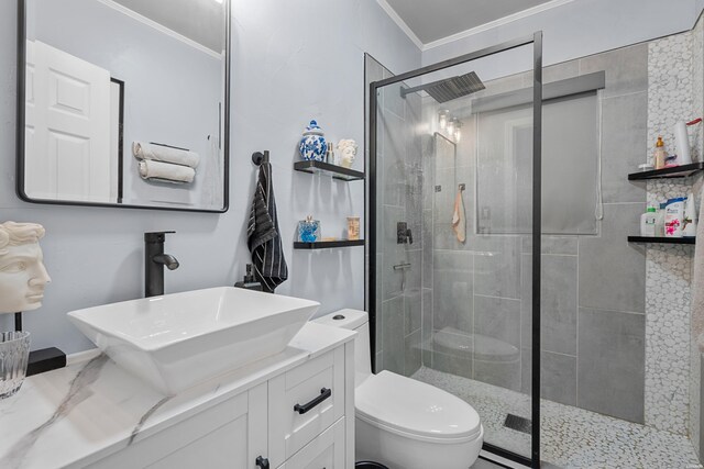 full bathroom with toilet, ornamental molding, a shower stall, and vanity